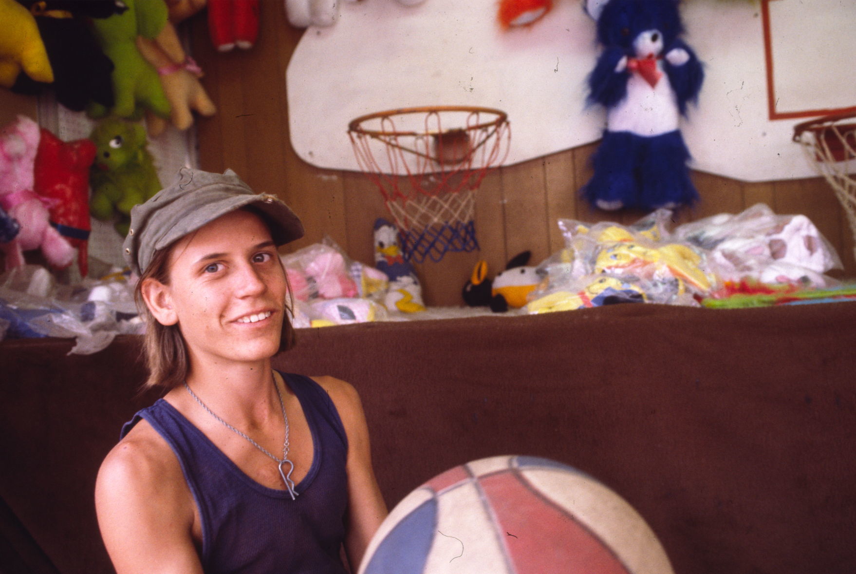 Carny at basketball shooting game